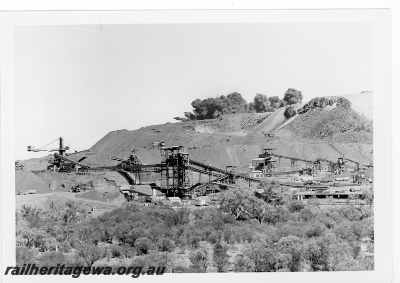 P19223
Mount Newman Mining (MNM) Newman mine- blast over Mount Whaleback crusher and loadout tunnel in foreground.
