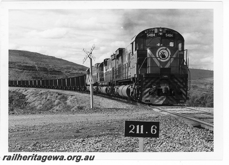 P19231
Mount Newman Mining (MNM) M636 class 5484 leads 2 other locomotives at the 211.6 kp level crossing near Newman. 
