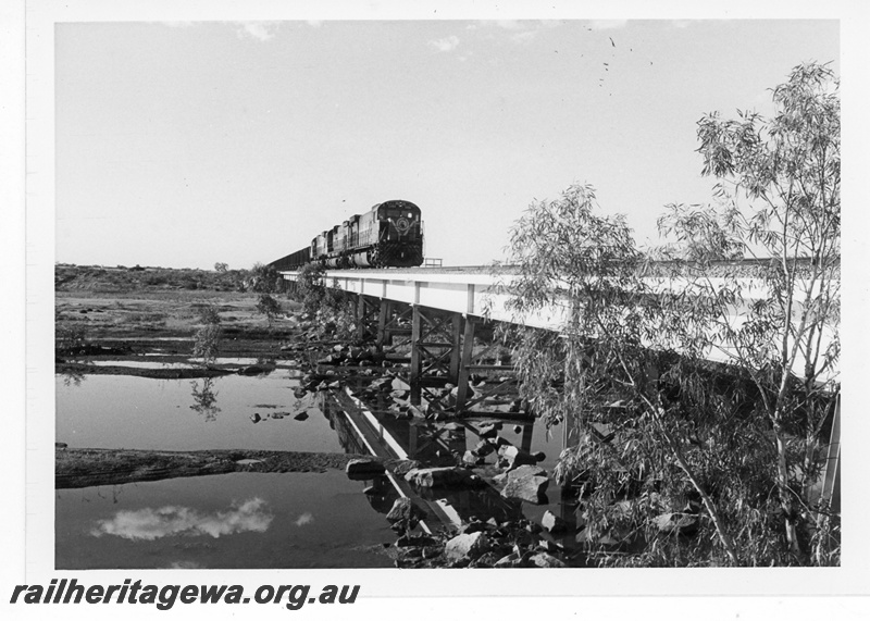 P19237
Mount Newman Mining (MNM) C636 class 5454 leads an empty ore train over the Turner River bridge near Gillam.
