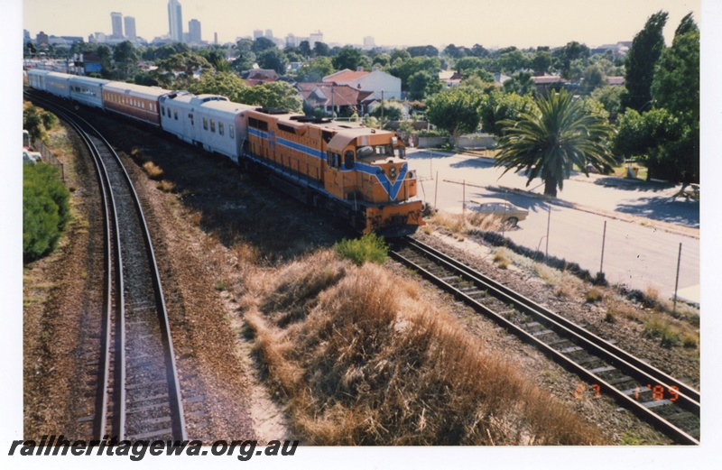 P19269
L class 258, in orange livery with blue and white stripe, on passenger carriages, near East Perth, ER line, side and front view

