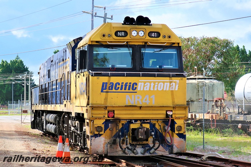 P19306
Pacific National NR class 41, yellow and blue livery, passing through the site of the Rail Transport Museum enroute to UGL plant, Bassendean, mainly a front on view
