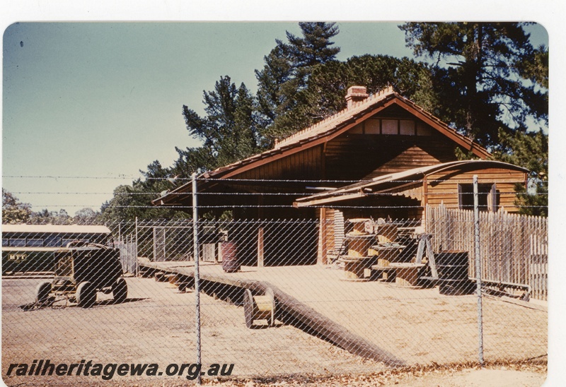 P19346
Ladies waiting room (Portable shelter shed), station building, Kalamunda, UDRR, view along the platform when the station yard was being used an a MTT bus depot.

