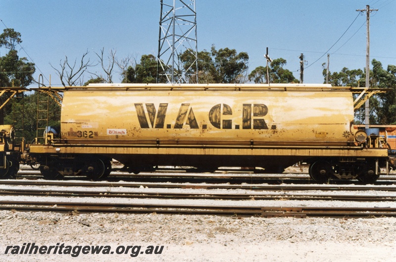 P19389
XWA class 21362 grain hopper, yellow livery with large lettered WAGR on the side, Kwinana, side view
