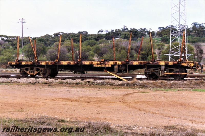 P19396
QBE class 2518 bogie flat wagon with stanchions, yellow livery, West Toodyay, side view

