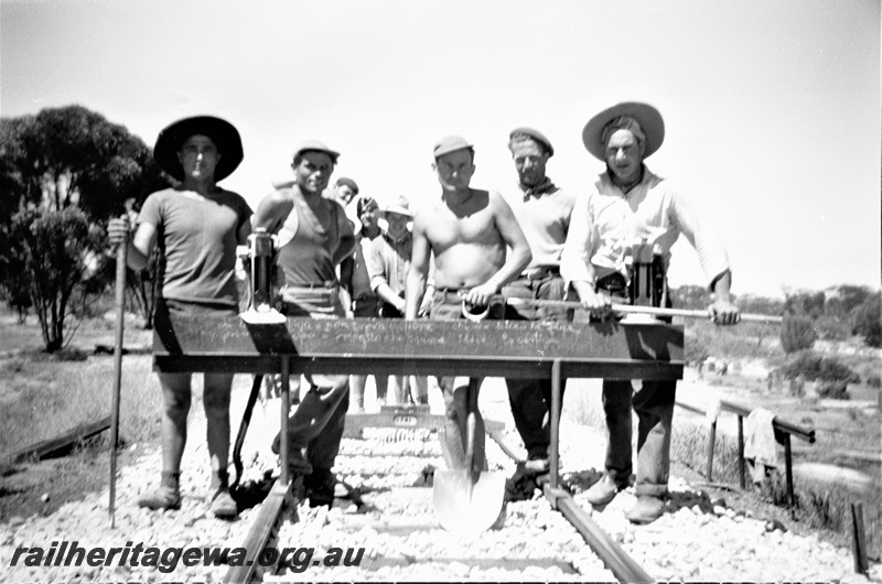 P19506
1 of 6 images of rail maintenance crew on EGR line, rail spacing gauge, tools, note lack of special work clothing
