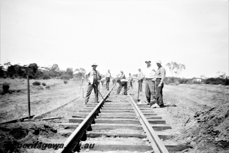 P19508
3 of 6 images of rail maintenance crew on EGR line, manual track laying, note lack of special work clothing 
