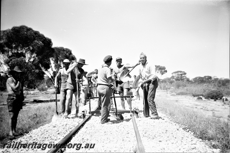 P19511
6 of 6 images of rail maintenance crew on EGR line, crew at work, rail spacer, tools, note lack of special work clothing
