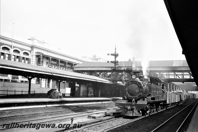 P19512
DS class 380, on goods train, bracket signals, station building, platforms, canopies, pedestrian overpass, Perth city station, view from platform
