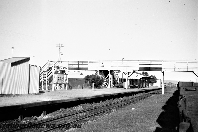 P19514
Station buildings, platform, pedestrian footbridge, track, Queens Park, SWR line, trackside view
