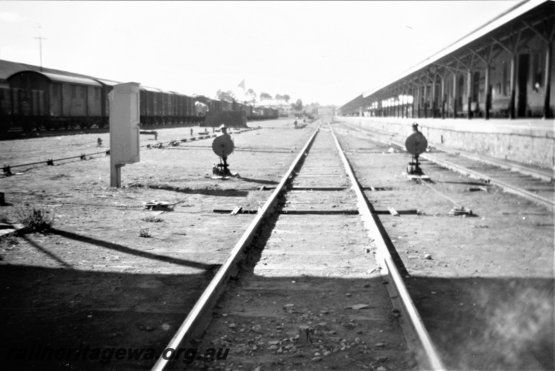 P19516
Point indicators, platform, rake of goods vans and wagons, platform, canopy, station building, Kalgoorlie, EGR line 
