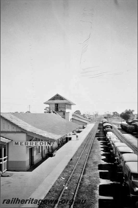 P19518
Station building, signal box, platform, canopy, rake of goods wagons in siding, Merredin, elevated view
