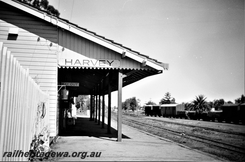 P19520
Station building, platform, canopy, yard sidings, rake of goods vans and wagons, station sign, Harvey, SWR line
