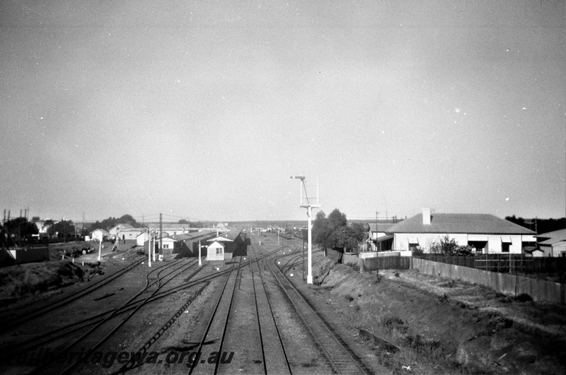 P19523
Overview of station and yard, station buildings, platform, canopy, bracket signal, signals, Kalgoorlie station, EGR line, view looking west from Maritana Street bridge

