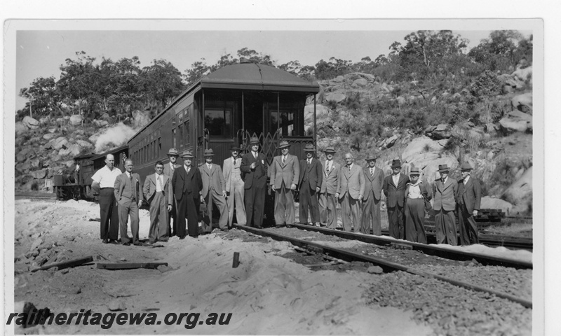 P19539
Group of suited gentlemen posing in front of AM class 313 Ministerial carriage at the opening of the deviation around the Swan View tunnel, east of Swan View, ER line
