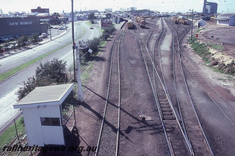 P19811
Shelter shed over a lever frame, rear view of a sommersault signal, elevated view of the yard looking west, Bunbury, SWR line 
