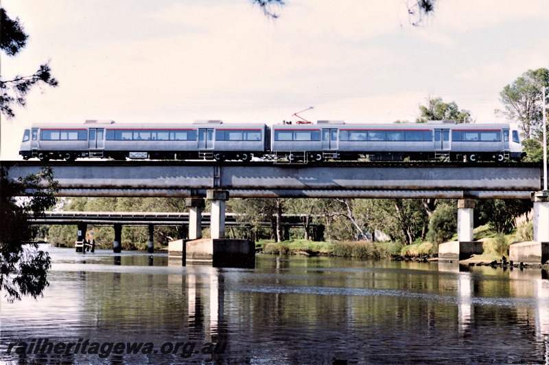 P19873
AEB/AEA class EMU set with the red stripe above the windows crossing the steel girder bridge over the Swan River at Guildford, side view
