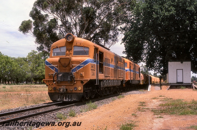 P19983
XA class 1401, and another XA class diesel, both in Westrail orange livery with blue and white stripe, double heading goods train, platform, station building, Boyanup, BB line, front and side view
