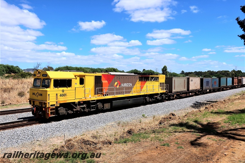 P19998
Aurizon Q class 4001 in the yellow with red and grey stripes livery heading south through Hazelmere on a freight train.
