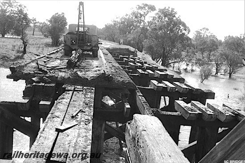 P21199
The trestle bridge over the Swan River on the Belmont Branch being demolished, view along the bridge.
