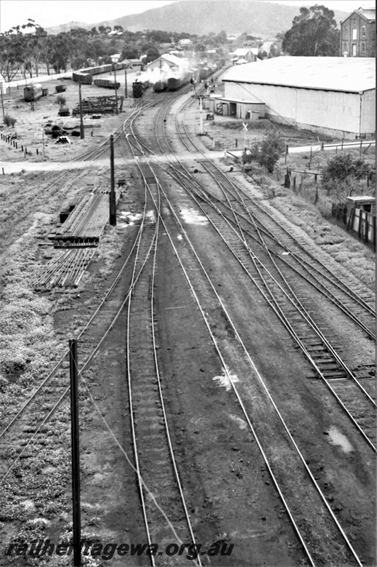 P21927
Loco depot yard, including points, sidings, scissors crossover, level crossing, various trains at station in distance, trackside buildings, York, GSR line, elevated view from loco depot
