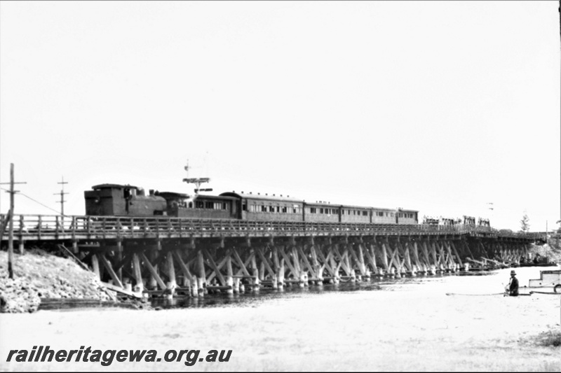 P21941
N class loco, tender first, on passenger train, crossing wooden trestle bridge, bracket signals, Swan River, Fremantle, ER line, front and side view
