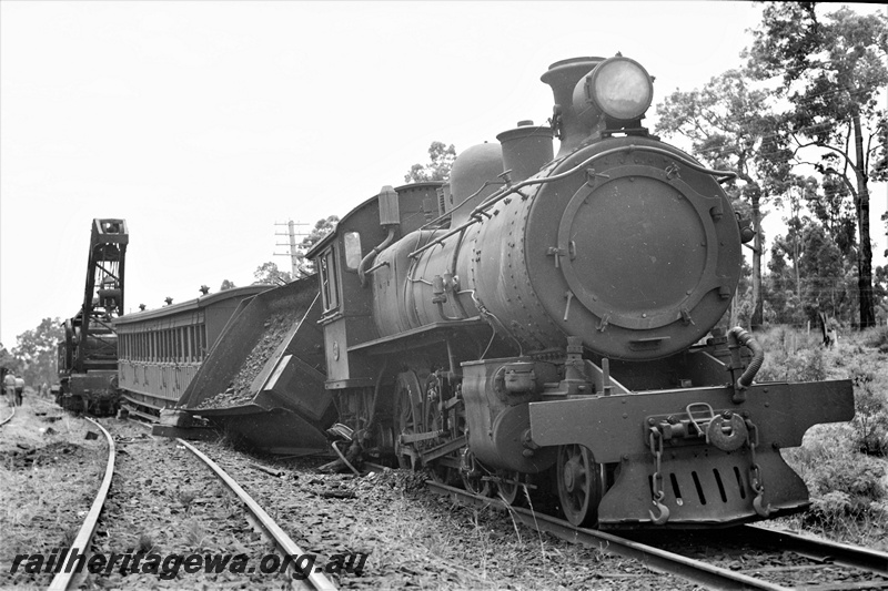P21946
E class 340  loco, with tender derailed, on passenger train, breakdown crane, Mount Helena, ER line, side and front view from trackside. Date of derailment 1/1/1946
