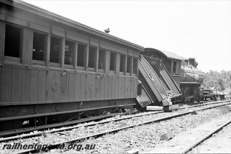 P21947
E class 340 loco, with tender derailed, on passenger train, Mount Helena, ER line, side view from rear of train at track level. Date of derailment 1/1/1946
