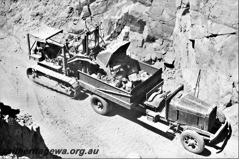 P21949
Excavator loading rock into tray truck, Swan View, ER line, view from an elevated position
