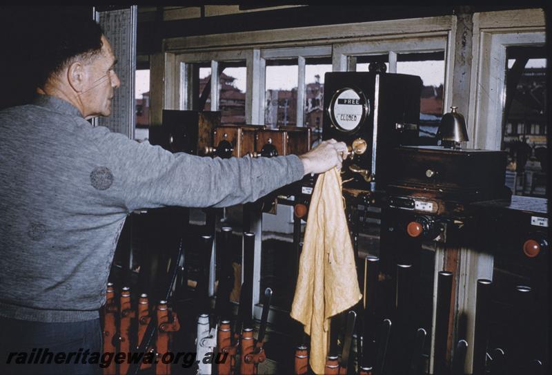 T03942
Signal box, internal view showing signalman and levers and other instruments
