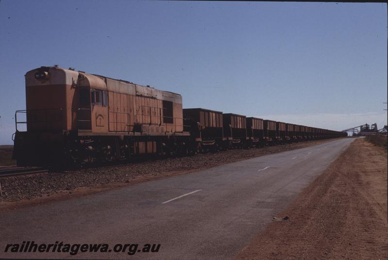 T04102
Goldsworthy Mining Limited English Electric loco A class 7, similar to WAGR K class, empty train, Finucane Island plant in background
