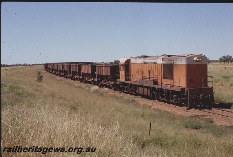 T04111
Goldsworthy Mining Limited English Electric loco A class 8, loaded train, Strelley River area, BHP line, 2 tank cars on rear of train
