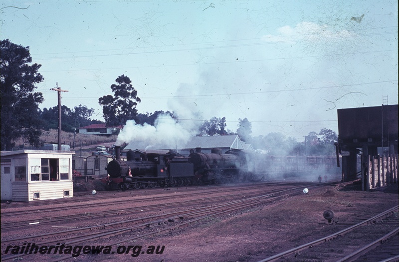 T04479
G class 123 and W class 945 steam locomotives with a goods train at Bridgetown, PP line, Note the water tower to the right and the weighbridge shed on the left.
