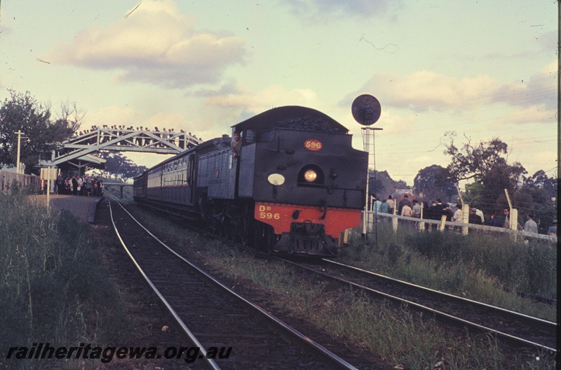 T04520
DD class 596 steam locomotive hauling a football special at West Leederville enroute to Perth. Note the passengers n the footbridge
