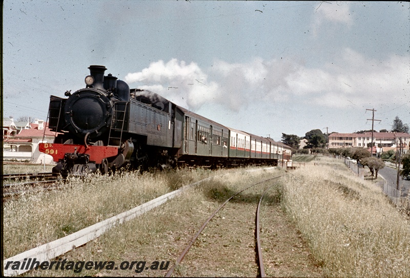 T04534
DD class 591 steam locomotive with a suburban passenger set travelling to Perth approaching Claremont .
