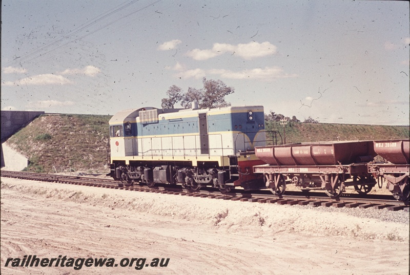T04644
J class 101 standard gauge diesel locomotive with a rake ballast train of 4 wheeled wagons at Kenwick. 
