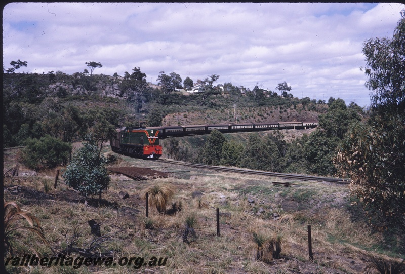 T04685
An unidentified A class diesel locomotive at the head of The Westland Express approaching the Swan View tunnel.
