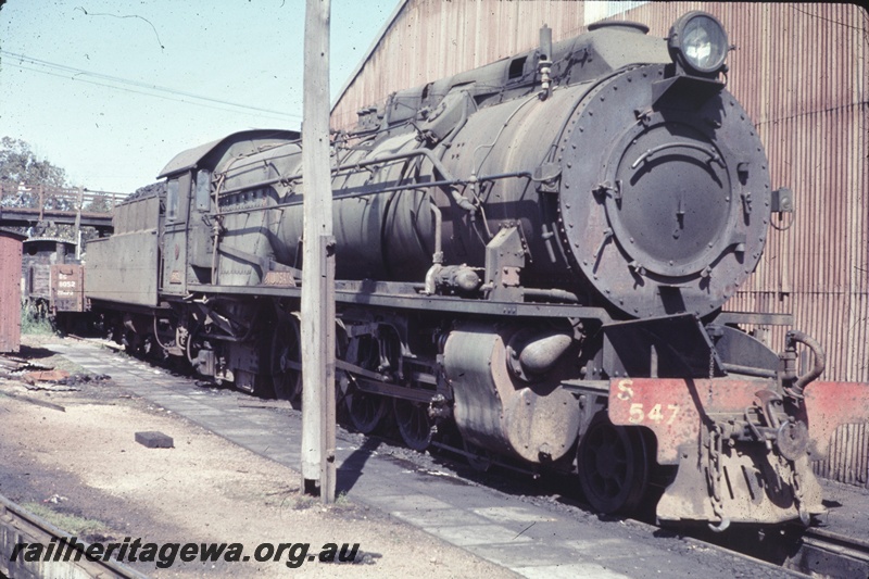 T04691
S class 547 steam locomotive pictured over the de-ashing pit, Bunbury loco depot, SWR line, H class 18 and GC class 8052 at the end of the line. GC class and number on the end of the GC wagon, 
