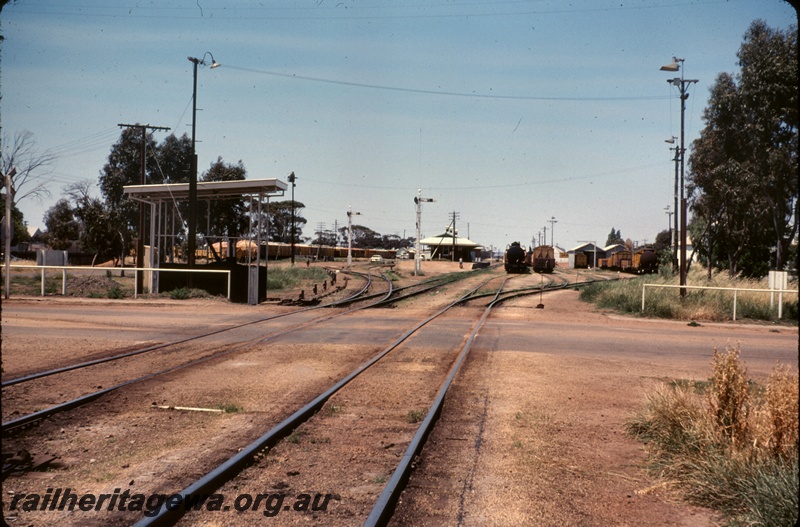 T04869
Station yard, road crossing, platform, station building, points, signals, sidings, goods shed, Wagin, ground level view
