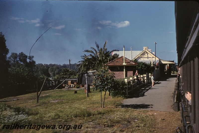 T05072
Station building, platform, onlookers, Gingin, MR line, photo taken from tour train at 20 mph running tender first
