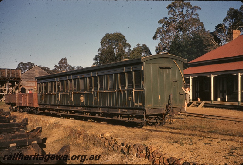 T05074
AA class 206 first class carriage in the plain green livery, open wagons, on ARHS tour train, water tower with a wooden tank, children, wooden building, station building, Jarrahdale, SWR line

