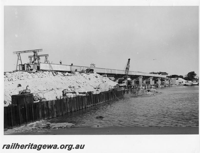 P00102
65 of 98 images showing views and aspects of the construction of the steel girder bridge with concrete pylons across the Swan River at North Fremantle.
