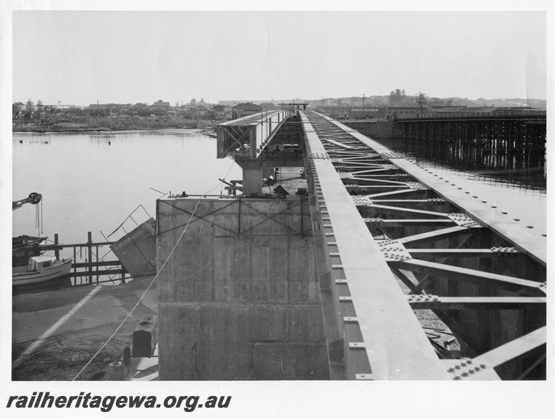 P00106
69 of 98 images showing views and aspects of the construction of the steel girder bridge with concrete pylons across the Swan River at North Fremantle.
