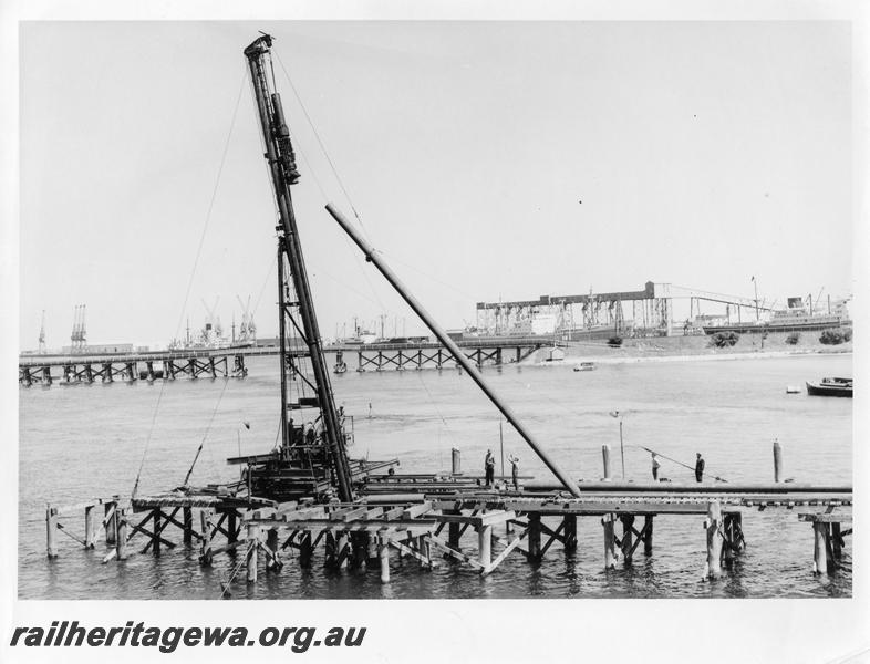 P00107
70 of 98 images showing views and aspects of the construction of the steel girder bridge with concrete pylons across the Swan River at North Fremantle.
