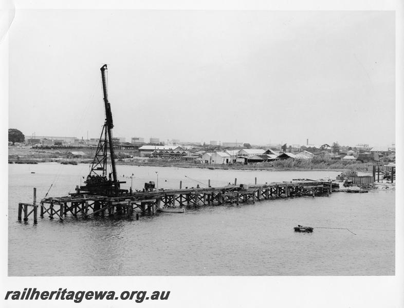 P00111
74 of 98 images showing views and aspects of the construction of the steel girder bridge with concrete pylons across the Swan River at North Fremantle.
