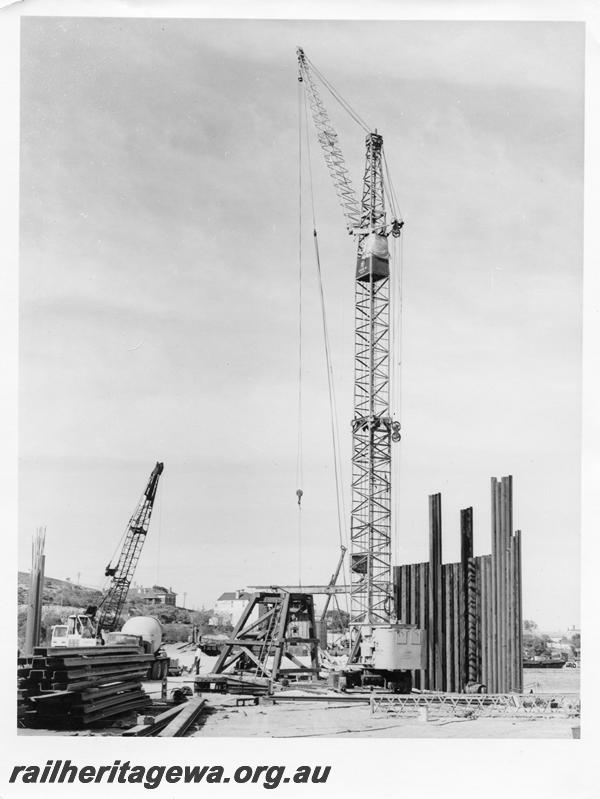 P00118
81 of 98 images showing views and aspects of the construction of the steel girder bridge with concrete pylons across the Swan River at North Fremantle.
