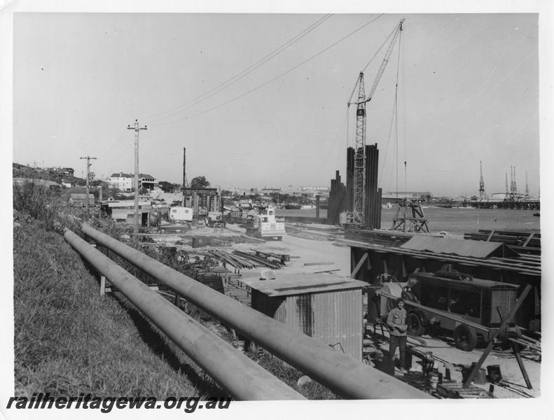 P00124
87 of 98 images showing views and aspects of the construction of the steel girder bridge with concrete pylons across the Swan River at North Fremantle.
