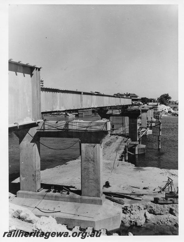 P00128
91 of 98 images showing views and aspects of the construction of the steel girder bridge with concrete pylons across the Swan River at North Fremantle.
