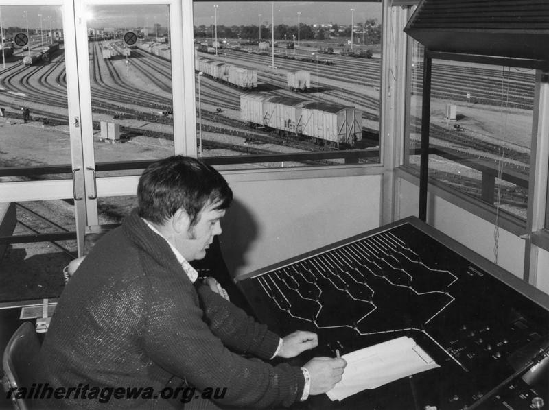 P00188
Hump yard operator sorting wagons, view of operator, consol and hump yard
