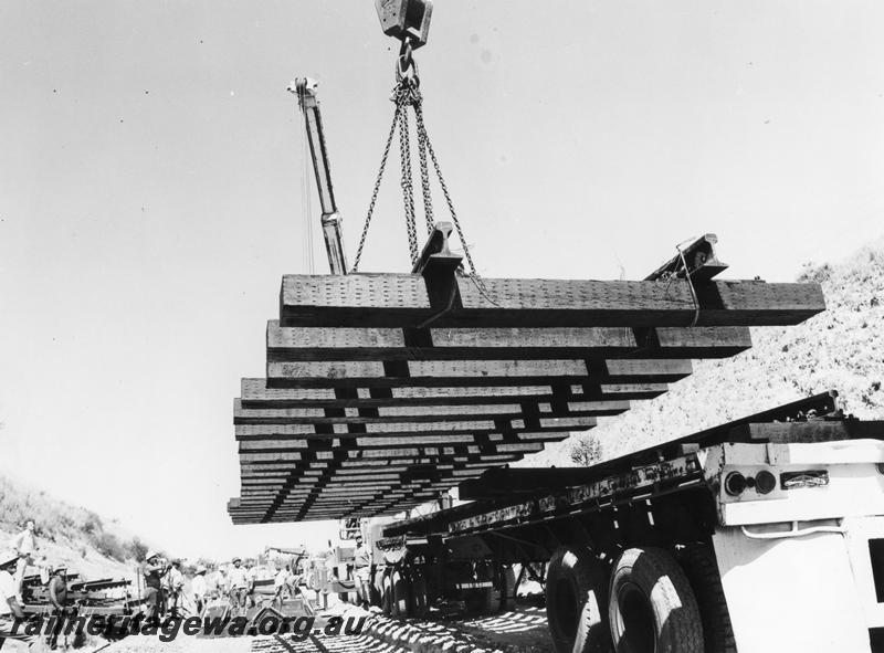 P00190
Panel of standard gauge track being lifted into position on the relaying of the line at Cockburn
