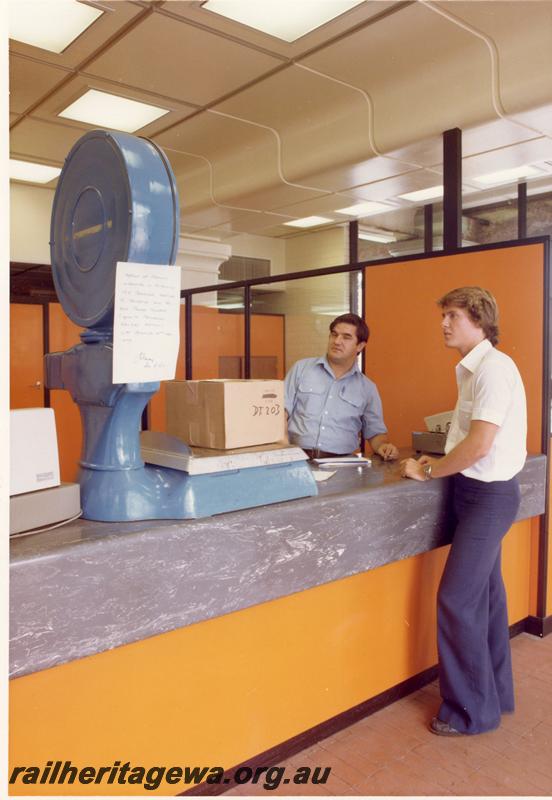 P00203
Staff weighing a parcel at the Parcel counter, City station
